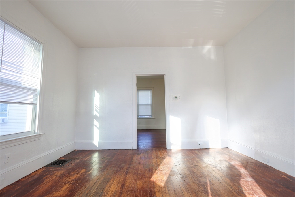 68 Newhall Street, Unit 68 Malden, MA 02148 - Photo 9 of 39 a view of a livingroom with wooden floor and a window