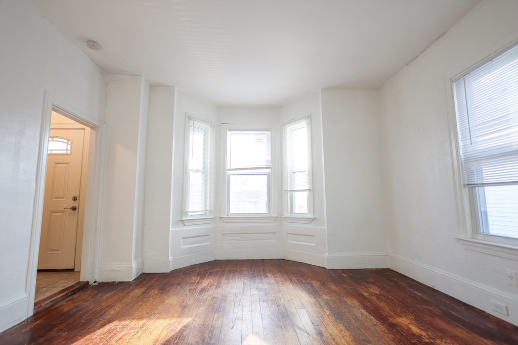 68 Newhall Street, Unit 68 Malden, MA 02148 - Photo 10 of 39 an empty room with wooden floor and windows