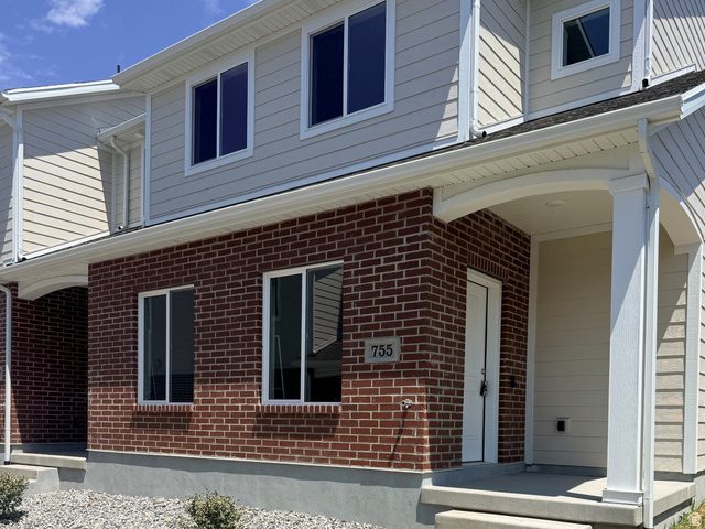 777 Pheasantbrook Drive, Unit 2B Centerville, UT 84014 - Photo 1 of 42 Two-story brick and siding construction featuring a covered front entry with white columns and a concrete walkway