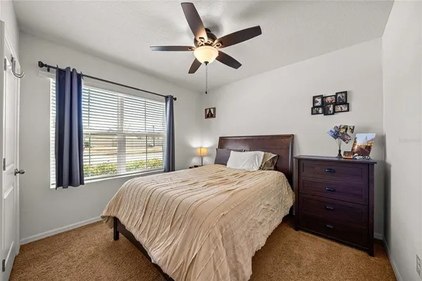 a bedroom with a bed and window