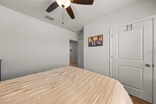 a bedroom with a bed and a painting on the wall