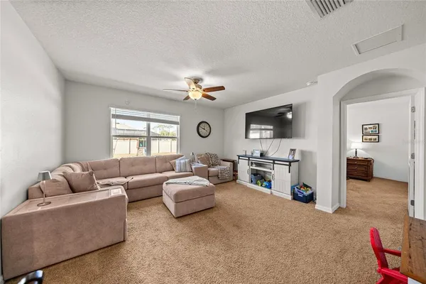 a living room with furniture and white walls