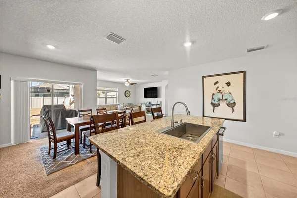 a living room with dining table and chairs