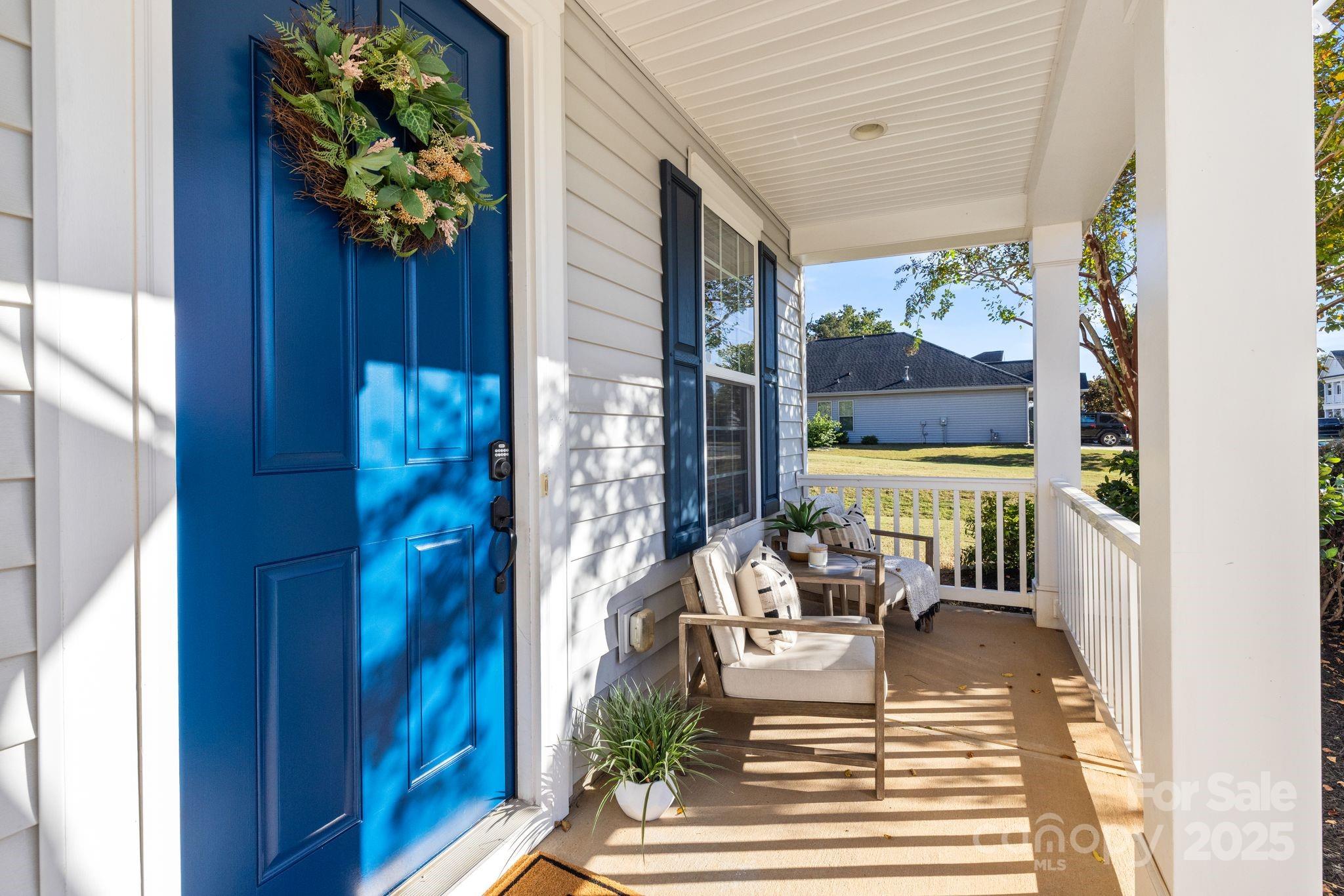 a view of a living room and a porch with furniture