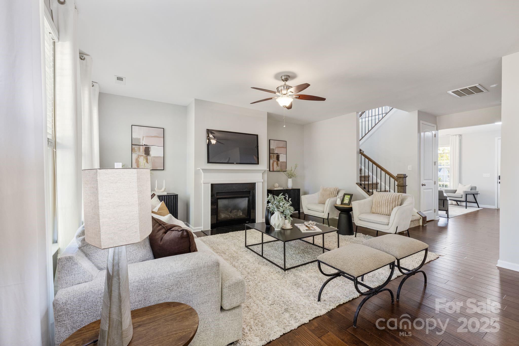 232 Morgan's Branch Road Belmont, NC 28012 - Photo 11 of 40 a living room with furniture a fireplace and a flat screen tv