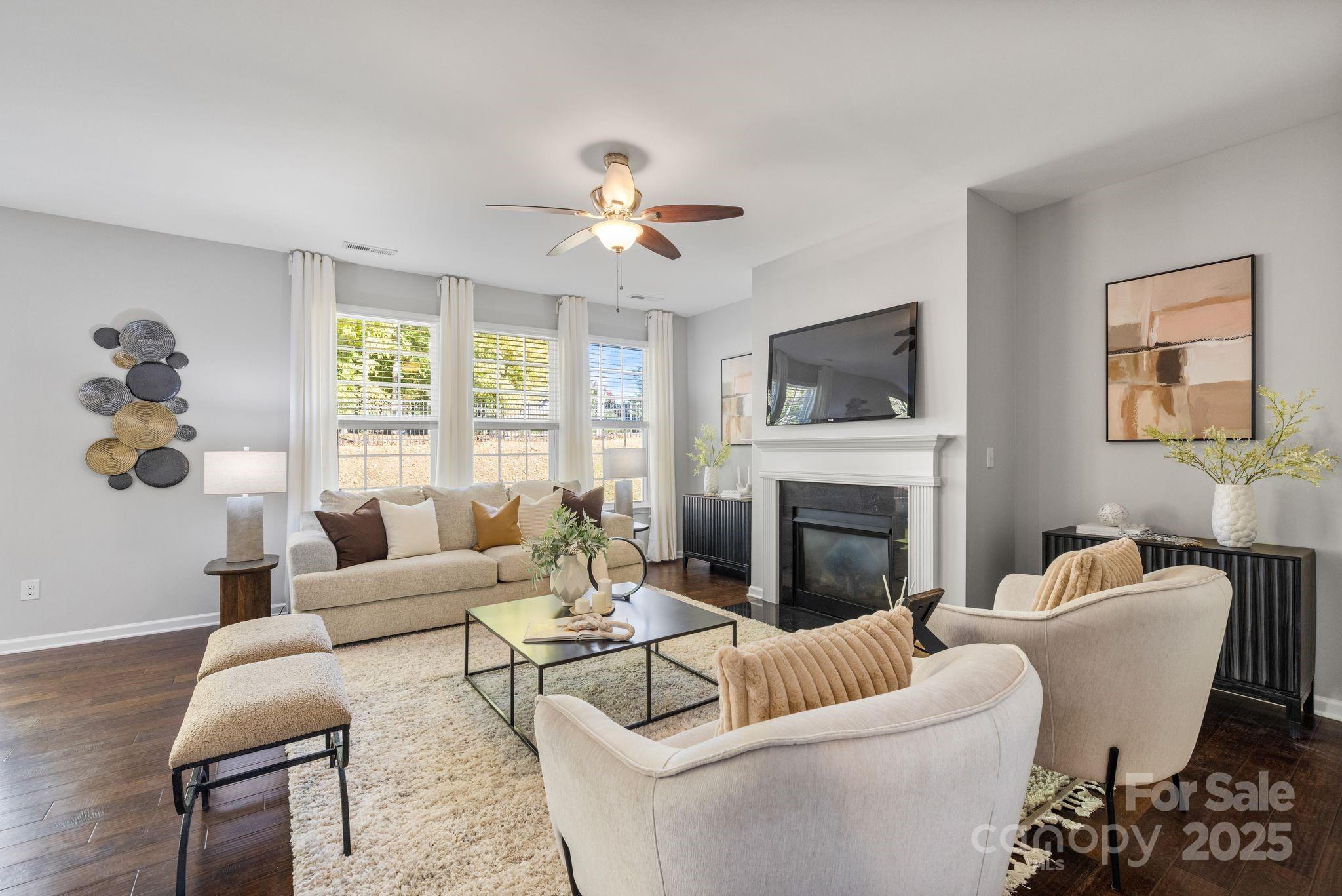 232 Morgan's Branch Road Belmont, NC 28012 - Photo 12 of 40 a living room with furniture a fireplace and a large mirror