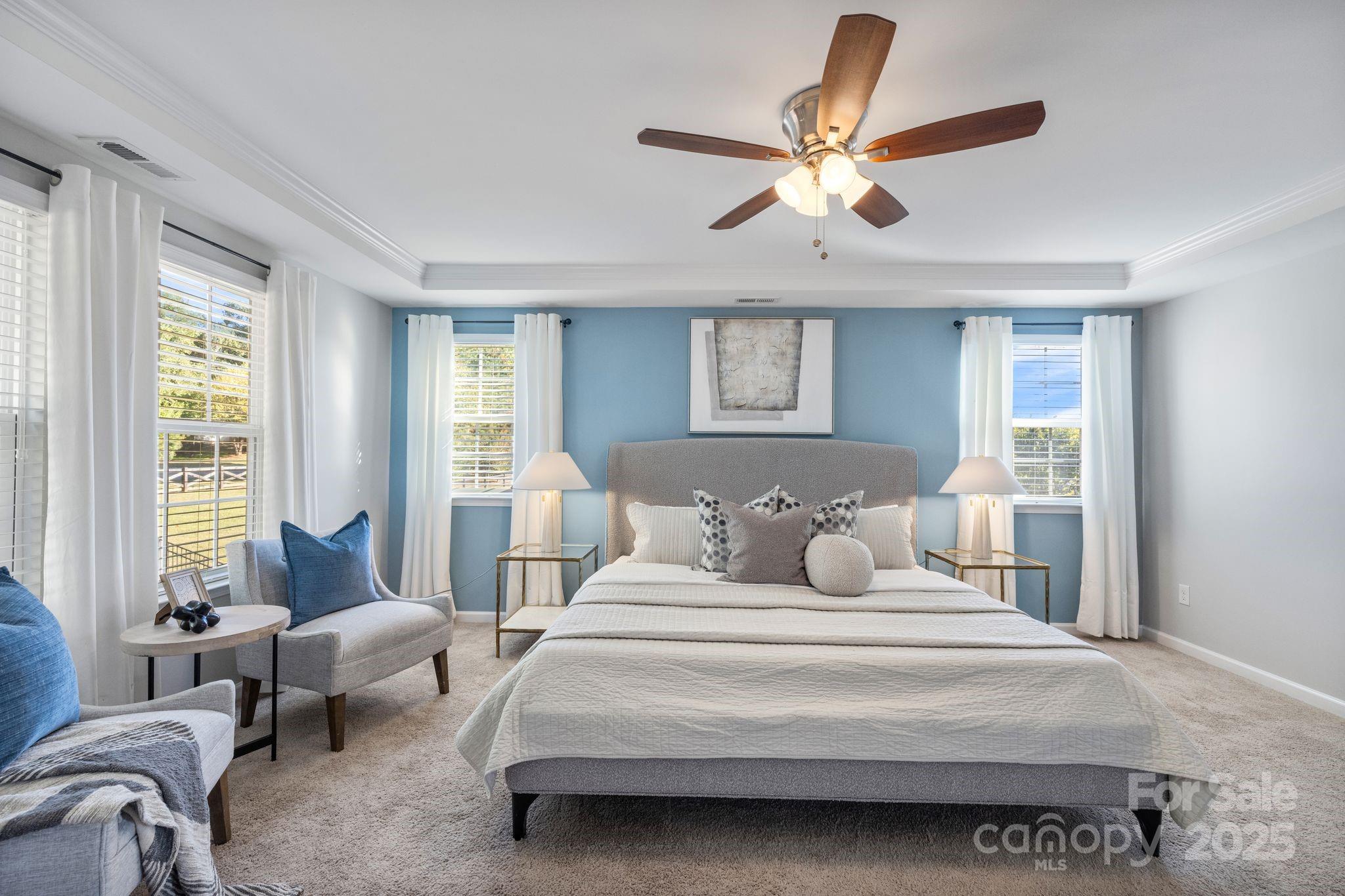 232 Morgan's Branch Road Belmont, NC 28012 - Photo 18 of 40 a bedroom with a large bed and a chandelier