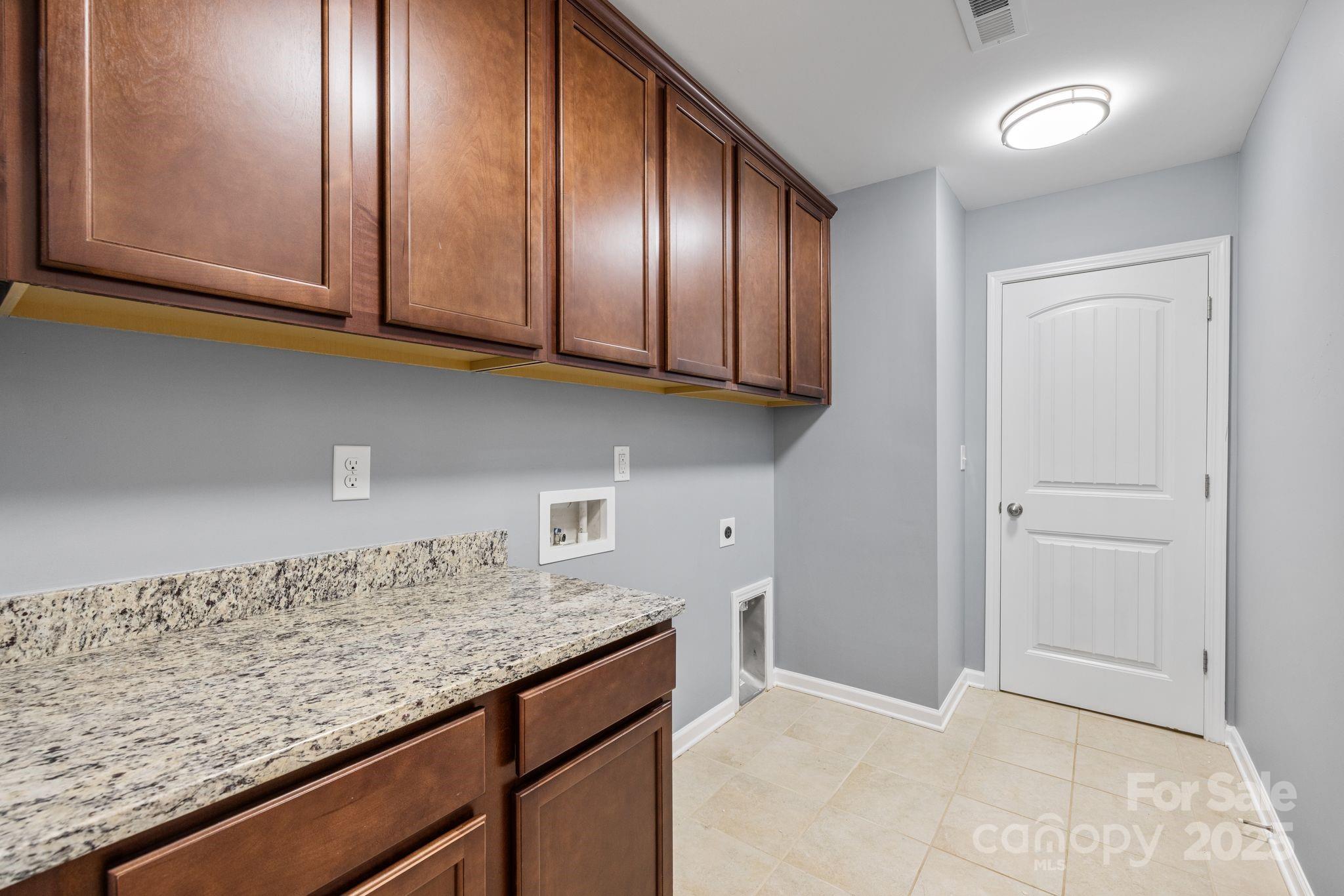 232 Morgan's Branch Road Belmont, NC 28012 - Photo 22 of 40 a kitchen with granite countertop cabinets and black stainless steel appliances