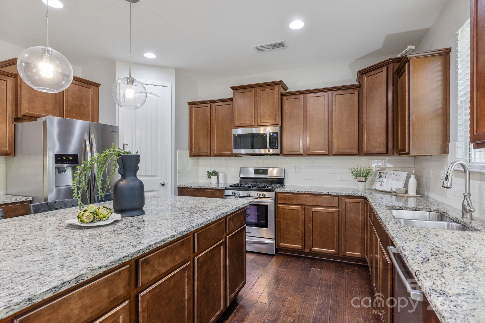 232 Morgan's Branch Road Belmont, NC 28012 - Photo 9 of 40 a kitchen with a sink stove and microwave