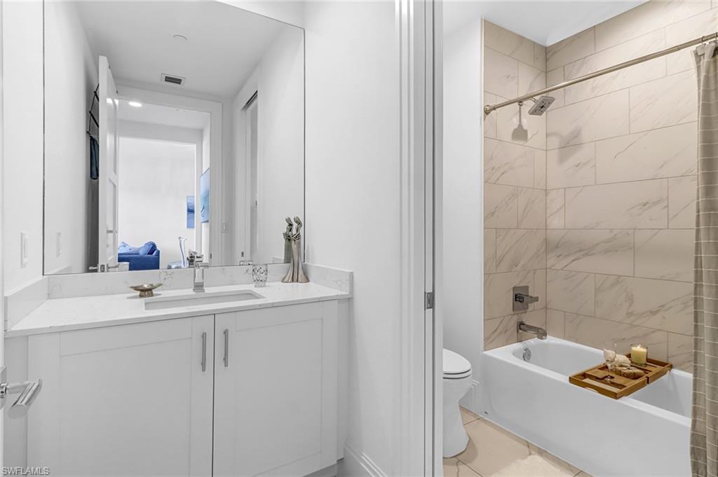 1135 3rd Avenue South, Unit 415 Naples, FL 34102 - Photo 10 of 25 a bathroom with a sink and a mirror