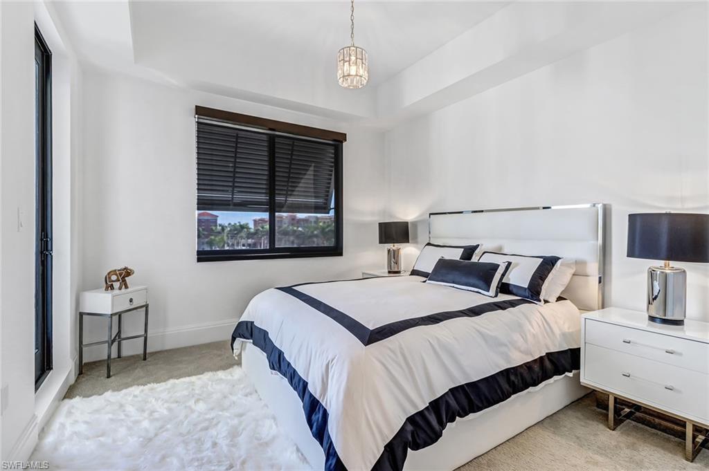 1135 3rd Avenue South, Unit 415 Naples, FL 34102 - Photo 15 of 25 a bedroom with a bed and a window