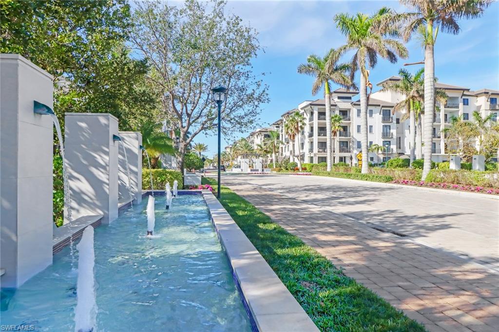 1135 3rd Avenue South, Unit 415 Naples, FL 34102 - Photo 24 of 25 a view of a building with a yard