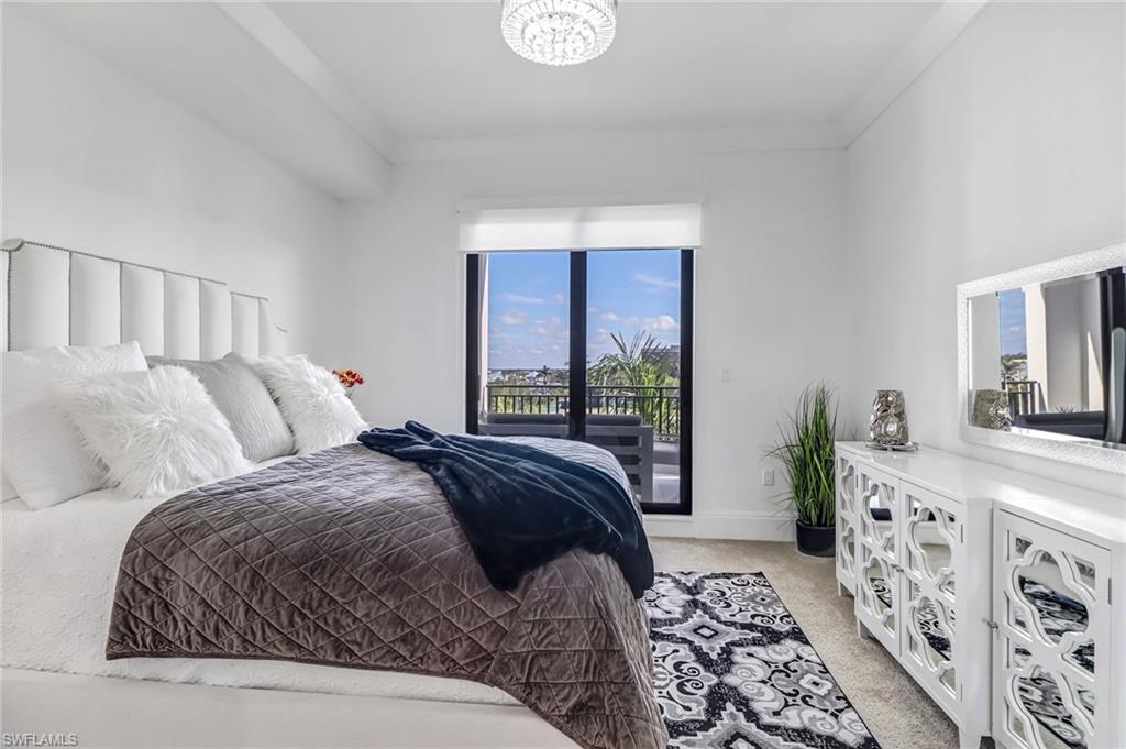 1135 3rd Avenue South, Unit 415 Naples, FL 34102 - Photo 6 of 25 a bedroom with a large bed and a window