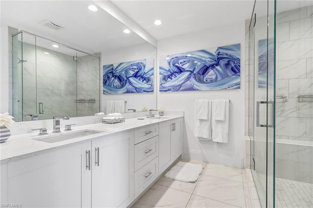 1135 3rd Avenue South, Unit 415 Naples, FL 34102 - Photo 8 of 25 a bathroom with a double vanity sink mirror and double