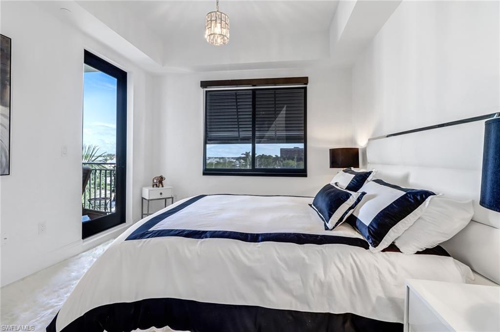 1135 3rd Avenue South, Unit 415 Naples, FL 34102 - Photo 9 of 25 a bedroom with a bed and a window