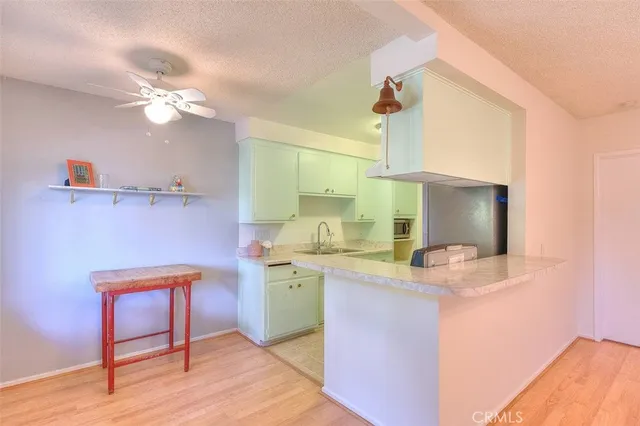 a kitchen with a sink cabinets and wooden floor