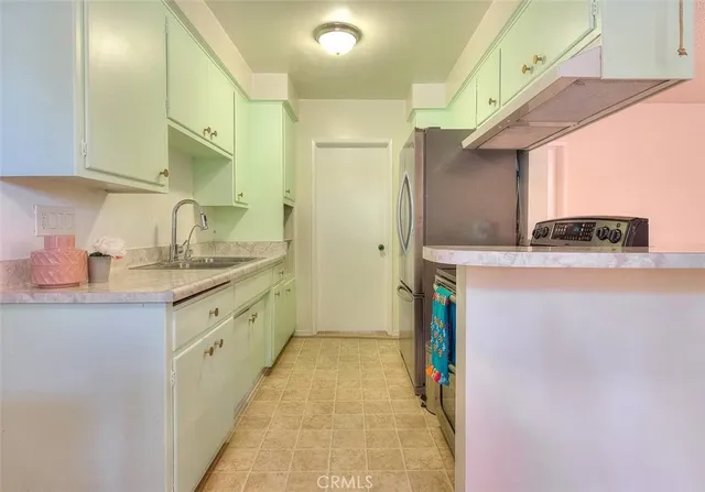a kitchen with stainless steel appliances granite countertop a sink and a stove top oven