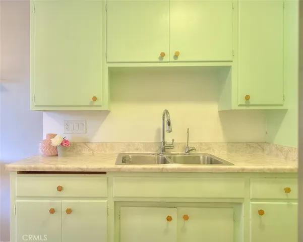 a close view of sink and cabinets