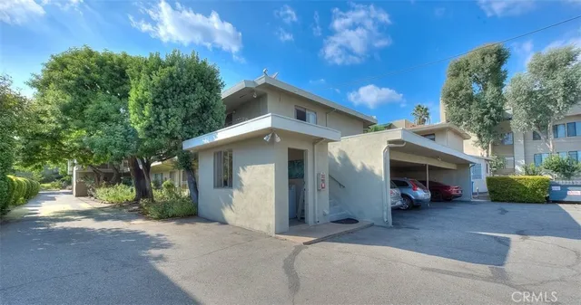 a view of a car park in front of house