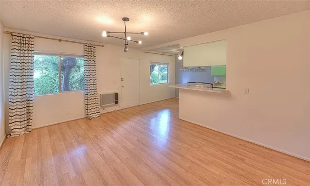 a view of a kitchen with wooden floor and a sink