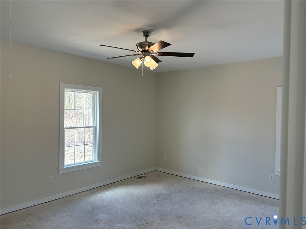 15085 Lebanon Road Disputanta, VA 23842 - Photo 15 of 17 an empty room with windows and fan