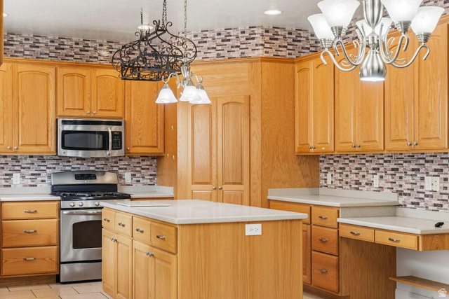 1001 Pine Valley Road Pine Valley, UT 84781 - Photo 18 of 49 Kitchen with hanging lights, stainless steel appliances, a center island, and tasteful backsplash