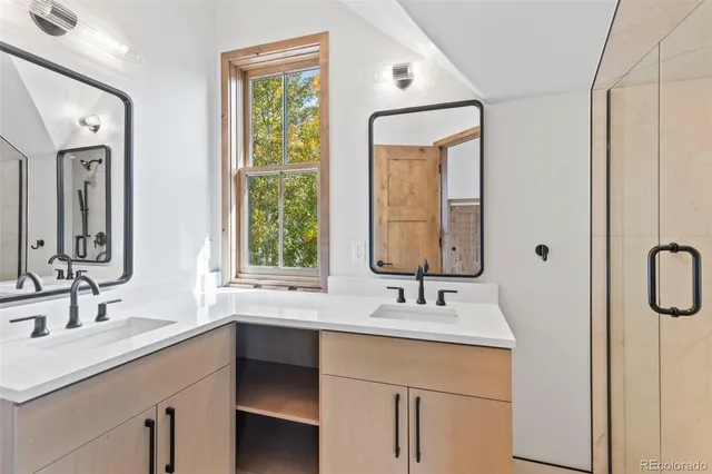 a bathroom with a double vanity sink mirror and double