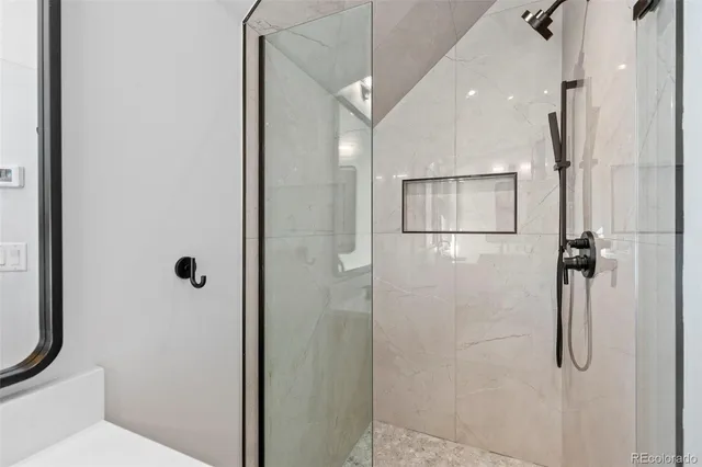 a bathroom with a shower and toilet