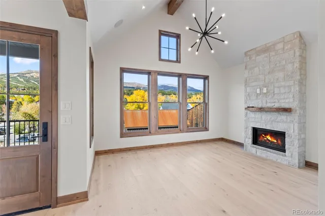 a view of an empty room with a fireplace and a window