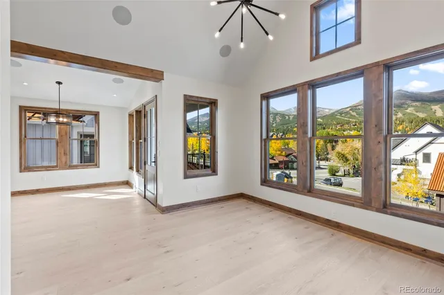 a view of an empty room with window and fire place