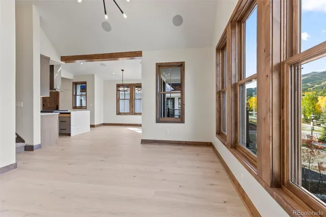 a view of an entryway with wooden floor and windows