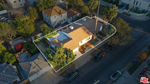 an aerial view of a house with a yard and outdoor seating
