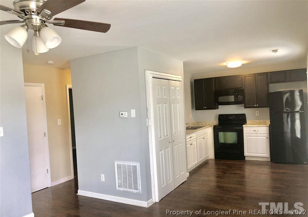 630 Middle Street, Unit 2 Durham, NC 27703 - Photo 2 of 5 a view of a kitchen with refrigerator and a stove top oven