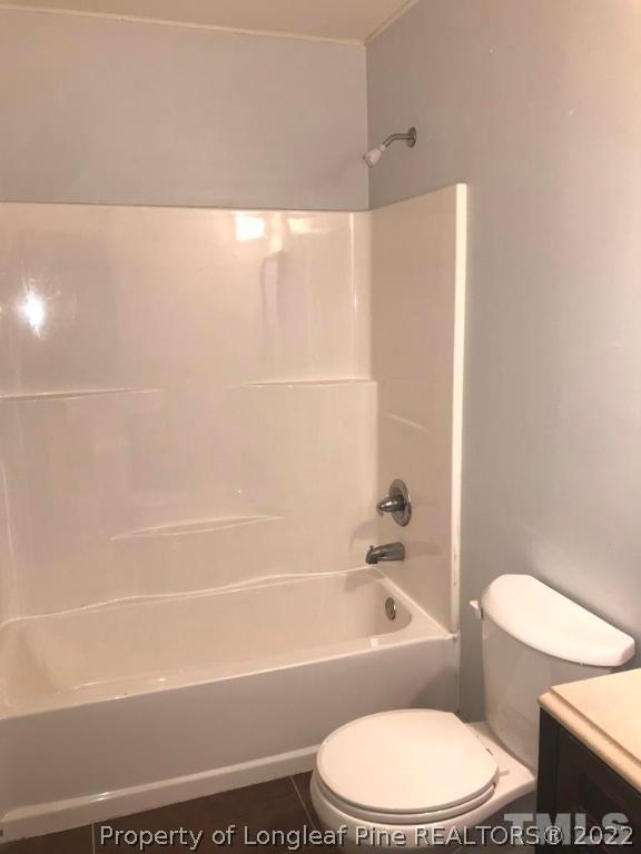 630 Middle Street, Unit 2 Durham, NC 27703 - Photo 5 of 5 a white toilet and tub next to a bathroom sink