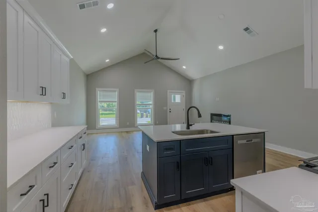 a kitchen with sink and cabinets