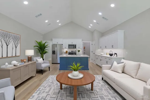 a living room with furniture and a dining table with kitchen view