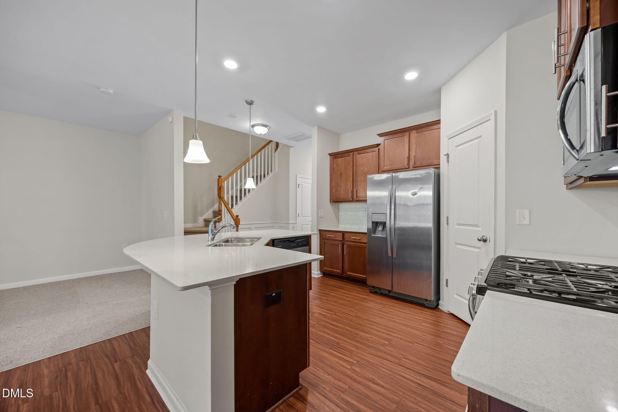 1005 Epiphany Road Morrisville, NC 27560 - Photo 5 of 23 a kitchen with stainless steel appliances a sink a stove a refrigerator and cabinets