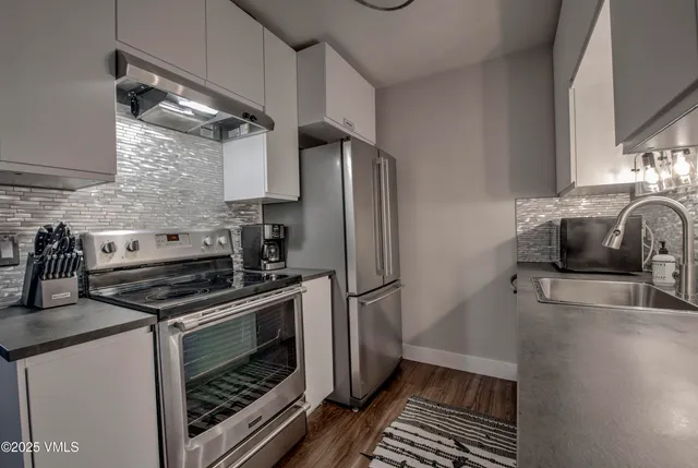 a kitchen with a stove and a refrigerator