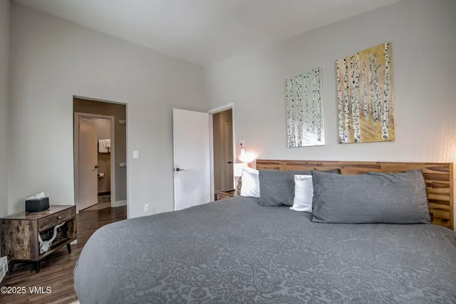 a spacious bedroom with a bed and cabinet