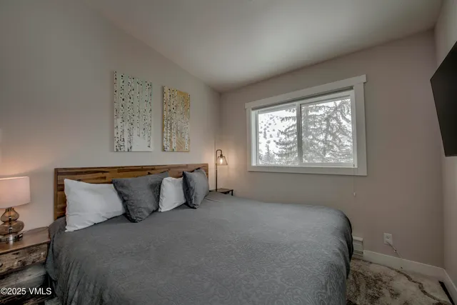 a bedroom with a bed and window