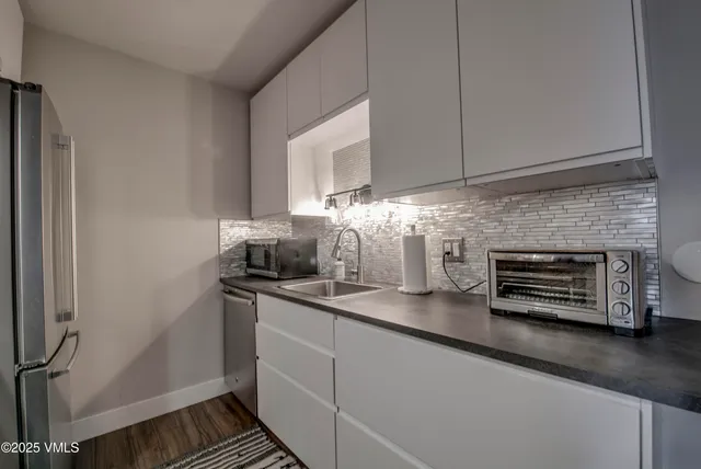 a kitchen with a sink and cabinets