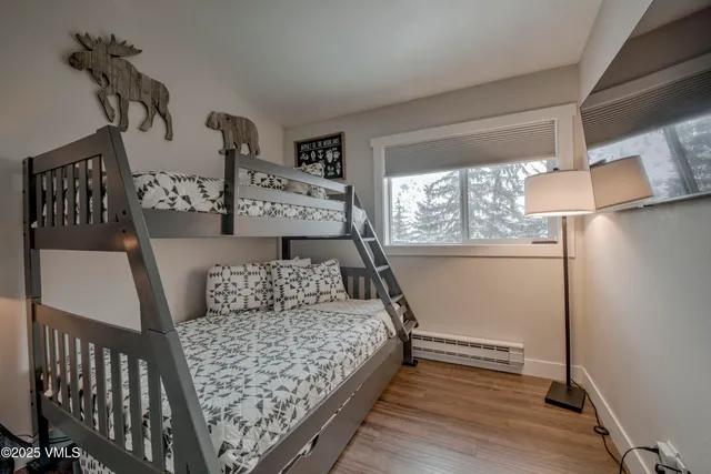 a bed sitting in a bedroom next to a window