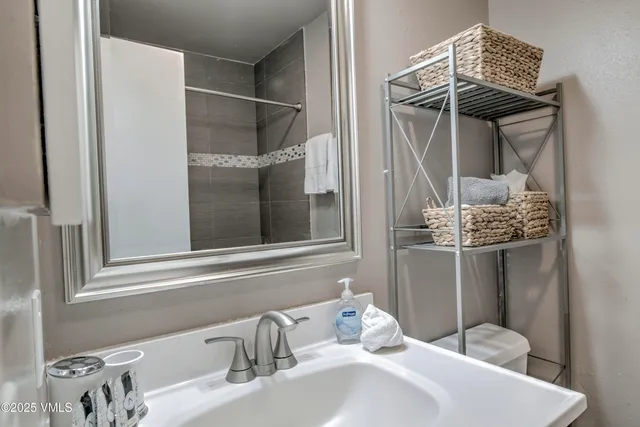 a bathroom with a sink and mirror
