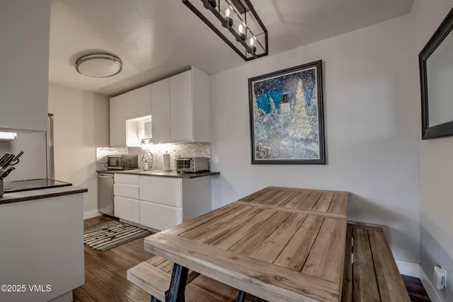 a kitchen with a table and cabinets
