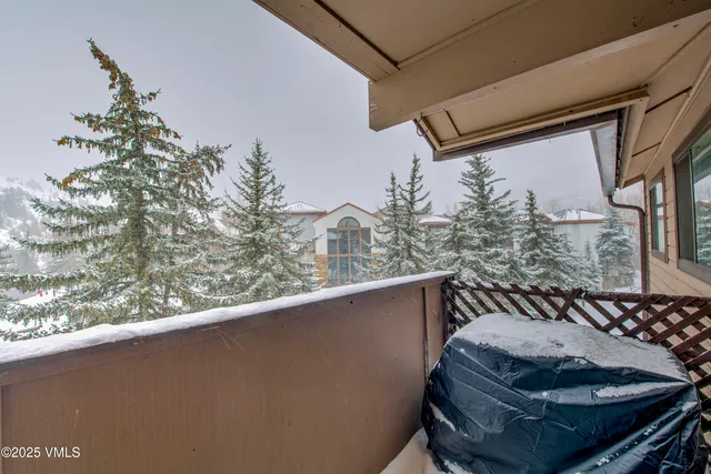 a balcony with table and chairs