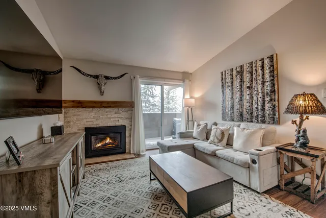 a living room with furniture and a fireplace