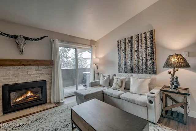 a living room with furniture and a fireplace