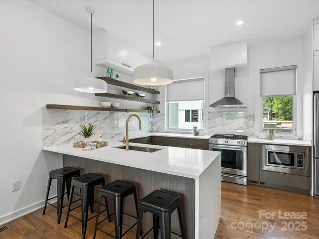 a kitchen with a table chairs stove and microwave