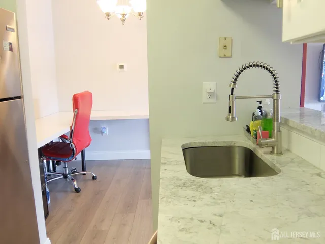 a view of a workspace with furniture and wooden floor