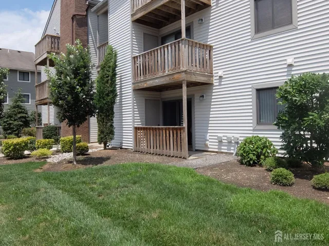 a view of a house with a yard and sitting area